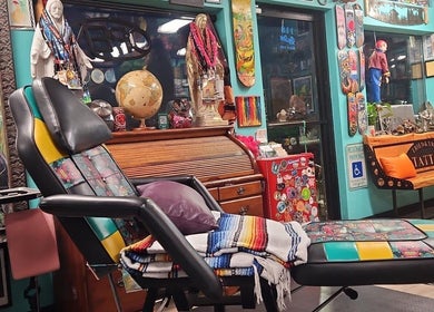 Colorful interior of Tony’s Tried & True Tattoo in Port Orchard, Washington, showcasing artsy decor and tattoo chair.