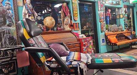 Colorful interior of Tony’s Tried & True Tattoo in Port Orchard, Washington, showcasing artsy decor and tattoo chair.