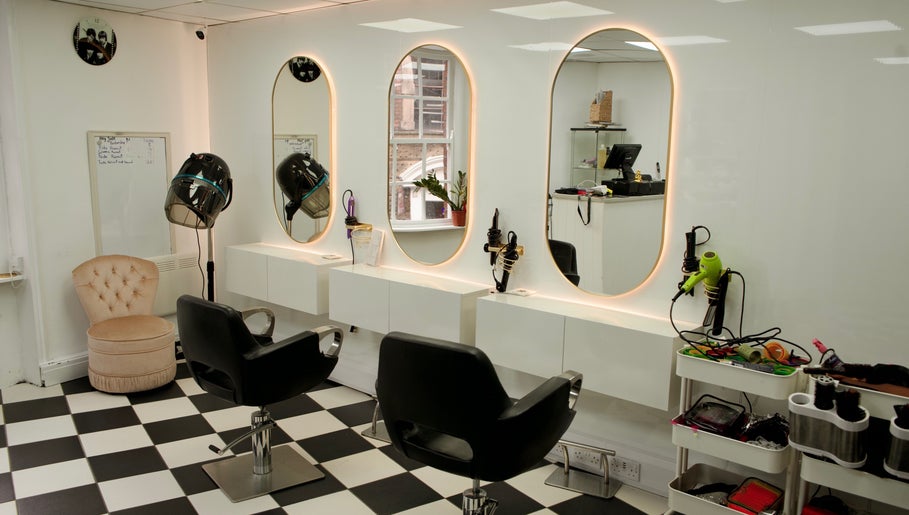 Elegant salon interior at Hey Jude, Liverpool, England, GB with chic mirrors and styling stations.