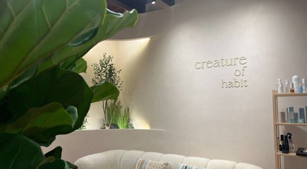 Elegant interior of Creature Of Habit, Singapore, SG showcasing stylish decor and greenery.