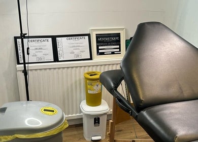 Treatment room at Ara Aesthetics (Home Services Available), Edgware, England, GB showcasing certificates and equipment.