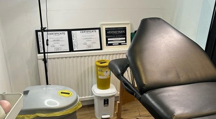 Treatment room at Ara Aesthetics (Home Services Available), Edgware, England, GB showcasing certificates and equipment.