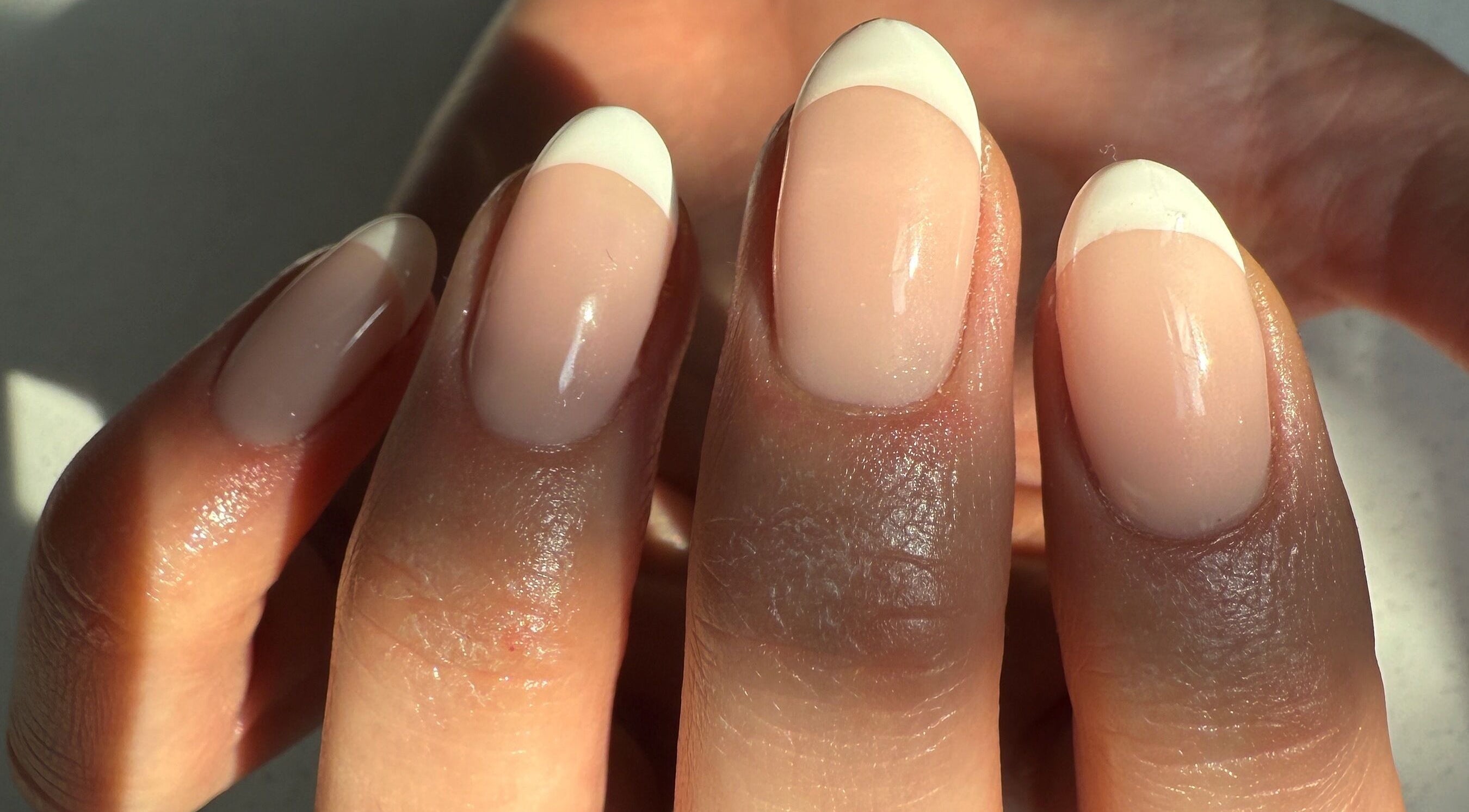 Elegant French manicure at bymiaxglover, Lowestoft, England, GB. Chic nail design with natural finish.