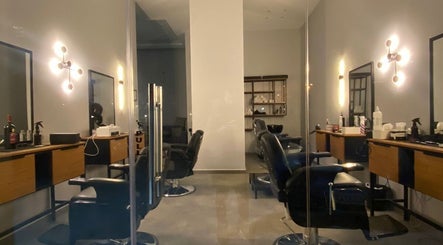 Modern barber chairs at Barber & Beauty House in Antelias, Jabal Lubnan, LB, with sleek decor and ambient lighting.