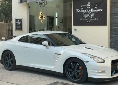 White sports car parked outside Barber & Beauty House, Antelias, Jabal Lubnan, LB.