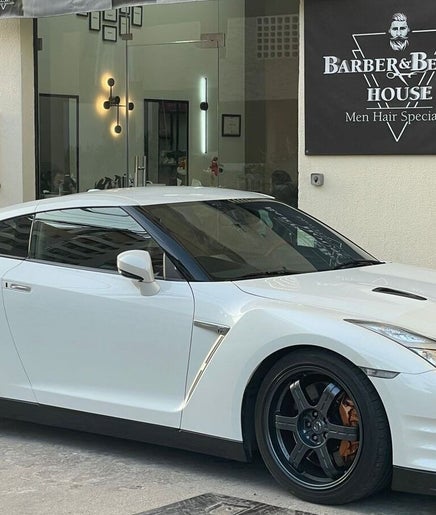 White sports car parked outside Barber & Beauty House, Antelias, Jabal Lubnan, LB.