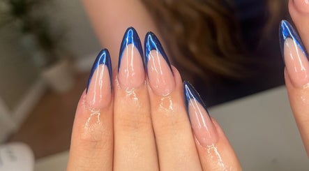 Close-up of glossy nails with blue tips at nailsbyreb_ in Bishopbriggs, Scotland, GB.