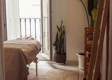 Tranquil massage room at Roxanne Gabriella, Home Visits, Andalucía, ES, featuring cozy bed and natural decor.