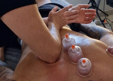Cupping therapy at Roxanne Gabriella, Home Visits, Andalucía, ES. Hands applying cupping on a back.