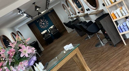 Elegant interior of Hair By HM at Chique, Mapplewell, England, GB featuring stylish decor and beauty products.