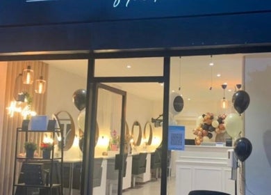 Elegant exterior of Aesthetica Nails & Aesthetics in Iver, England, GB, warmly lit and inviting.