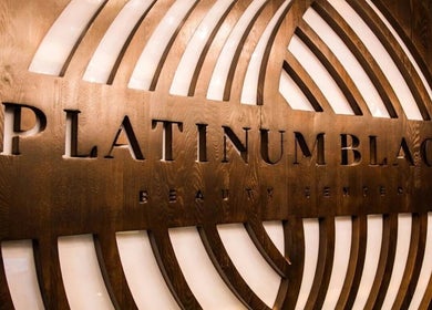 Elegant wooden signage at Platinum Black Gents Salon, Dubai, AE, featuring sleek design elements.