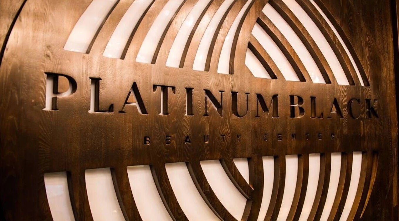 Elegant wooden signage at Platinum Black Gents Salon, Dubai, AE, featuring sleek design elements.