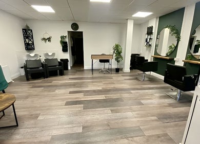 Modern interior of SalonNo7, Barry, Cymru, GB, featuring stylish chairs, mirrors, and greenery decor.
