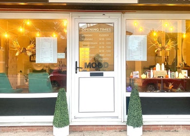 Front of SalonNo7 in Barry, Cymru, GB, warmly lit with elegant decor and opening hours displayed.