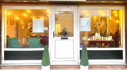 Front of SalonNo7 in Barry, Cymru, GB, warmly lit with elegant decor and opening hours displayed.
