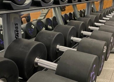 Dumbbells lined up at Lift with Kisha in Cyberjaya, Selangor, MY, highlighting a modern fitness facility.