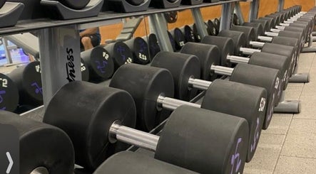 Dumbbells lined up at Lift with Kisha in Cyberjaya, Selangor, MY, highlighting a modern fitness facility.