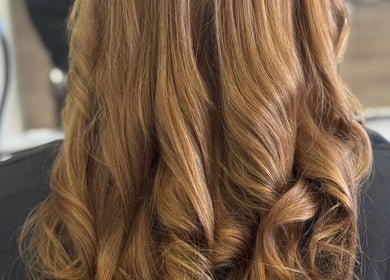 Stunning golden curls at Friel Good Hair, Glasgow, Scotland, GB showcasing hairstyling excellence.