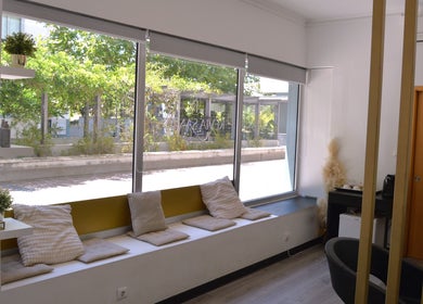 Inviting seating nook at Jorge Rodriguez Cabelereiro OLI Organic, Lisboa, Lisboa, PT, with large windows.