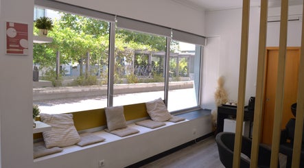 Inviting seating nook at Jorge Rodriguez Cabelereiro OLI Organic, Lisboa, Lisboa, PT, with large windows.
