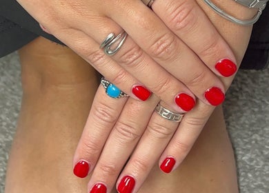 Elegant red manicure at The Mani Bar by Rebecca, Plains, Scotland, GB. Showcases vibrant, professional nail care.