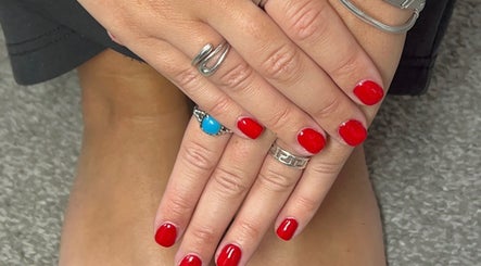 Elegant red manicure at The Mani Bar by Rebecca, Plains, Scotland, GB. Showcases vibrant, professional nail care.