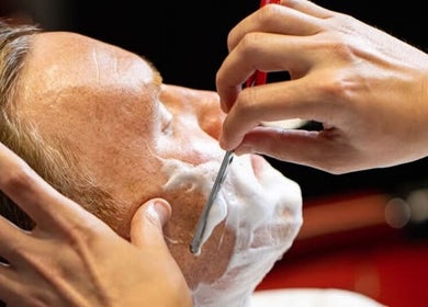 Close-up of a traditional straight razor shave at Usta Barbers in London, England, GB.