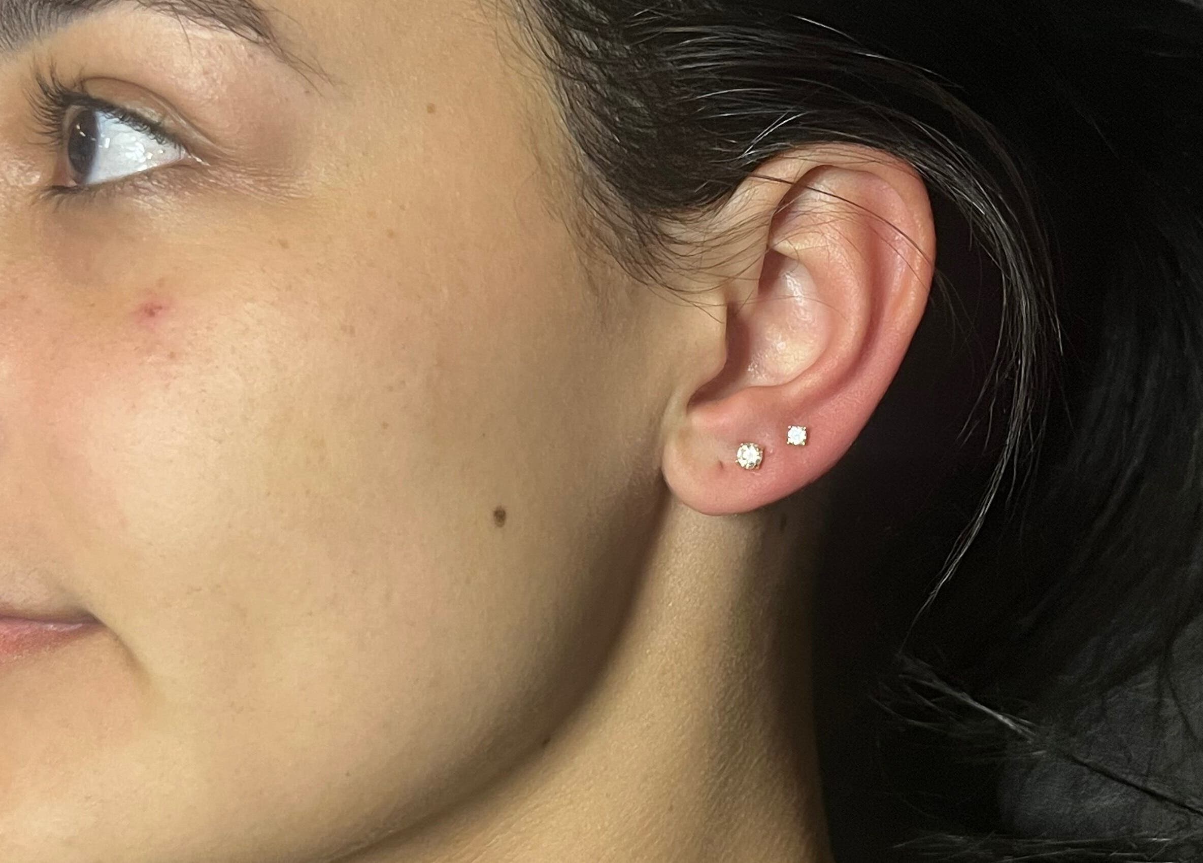 Close-up of a stylish ear piercing at IVRY, Pawling, New York, US showcasing elegant earring design.