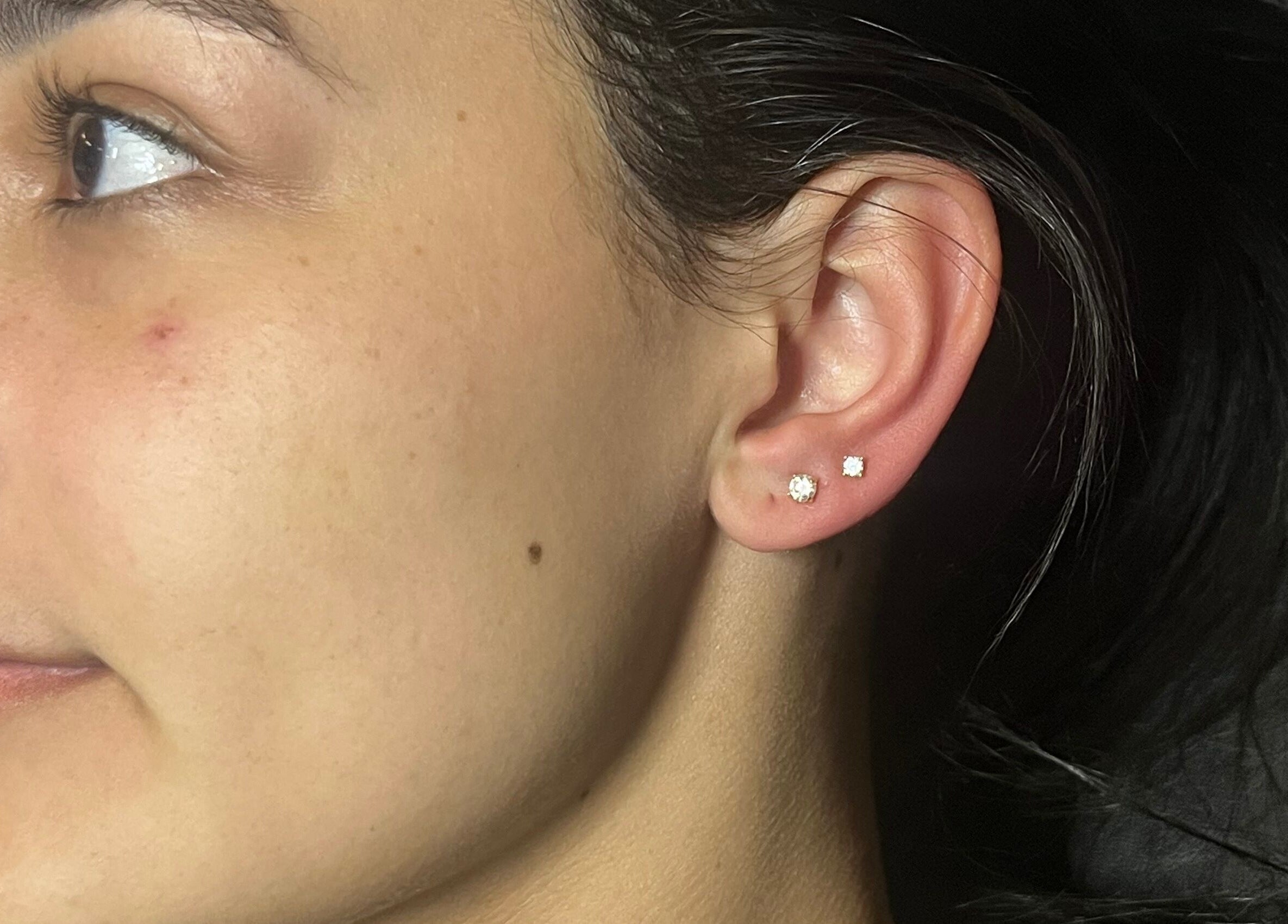 Close-up of a stylish ear piercing at IVRY, Pawling, New York, US showcasing elegant earring design.