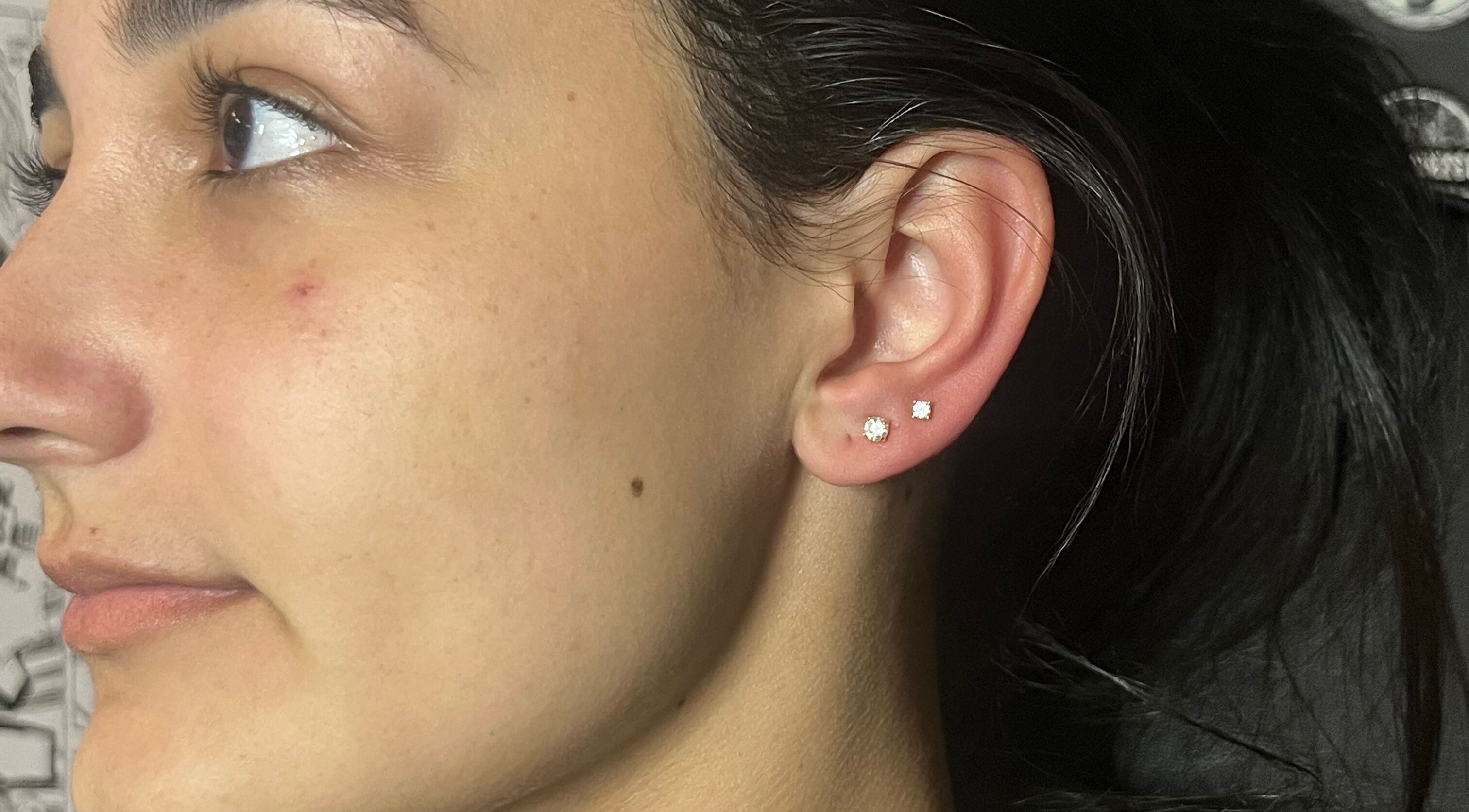 Close-up of a stylish ear piercing at IVRY, Pawling, New York, US showcasing elegant earring design.