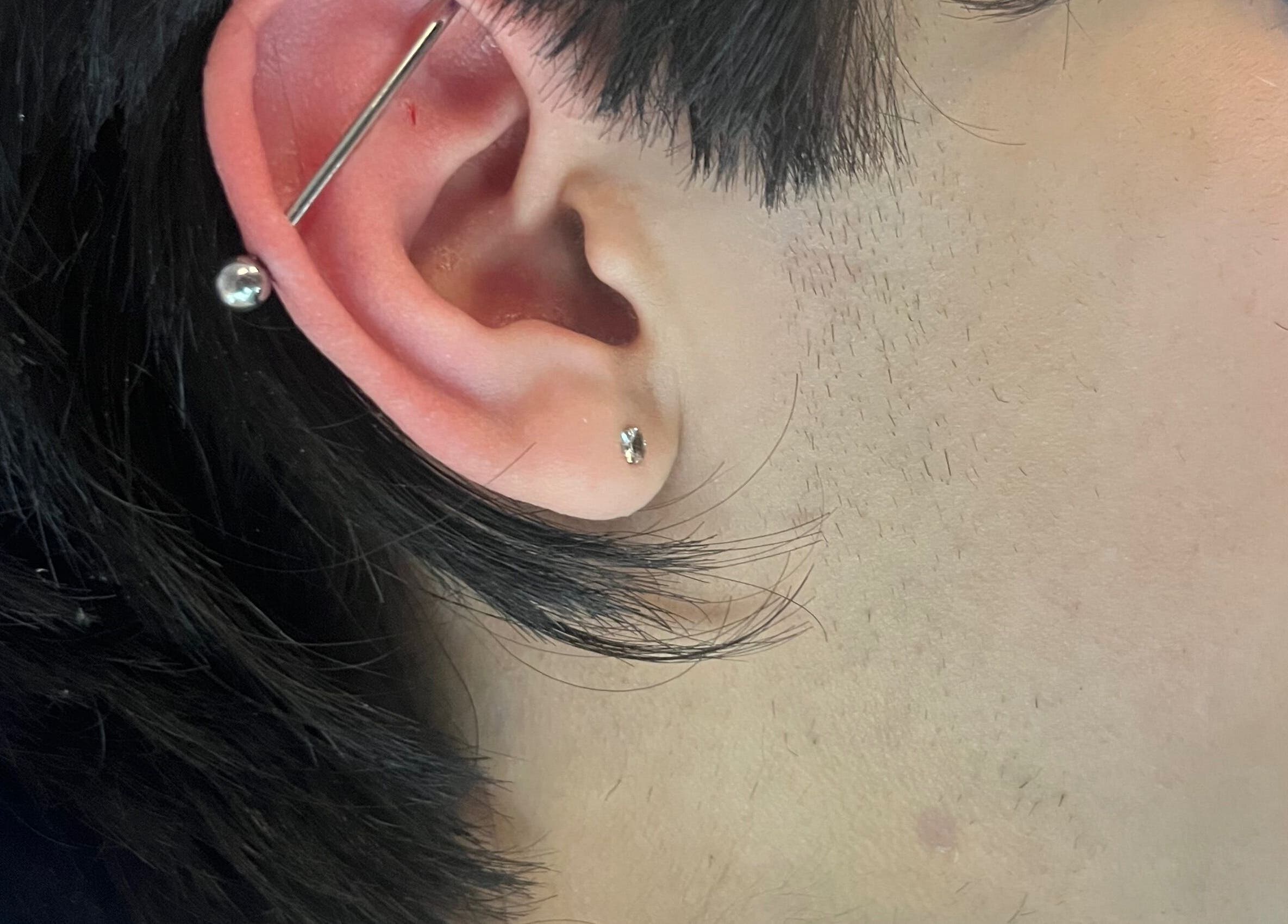 Close-up of stylish ear piercings at IVRY in Pawling, New York, US enhancing personal style.