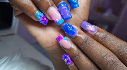 Vibrant floral nail art design at Rachella Creations, Oistins, Christ Church, BB. Stunning blue and purple hues.
