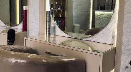 Phoebe salon's chic vanity setup at Marrakech, Marrakech-Safi, MA showcasing beauty products and mirror.