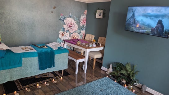Relaxing therapy room at The Chakra Shed, Birkenhead, England, GB, with floral art and calming teal decor.
