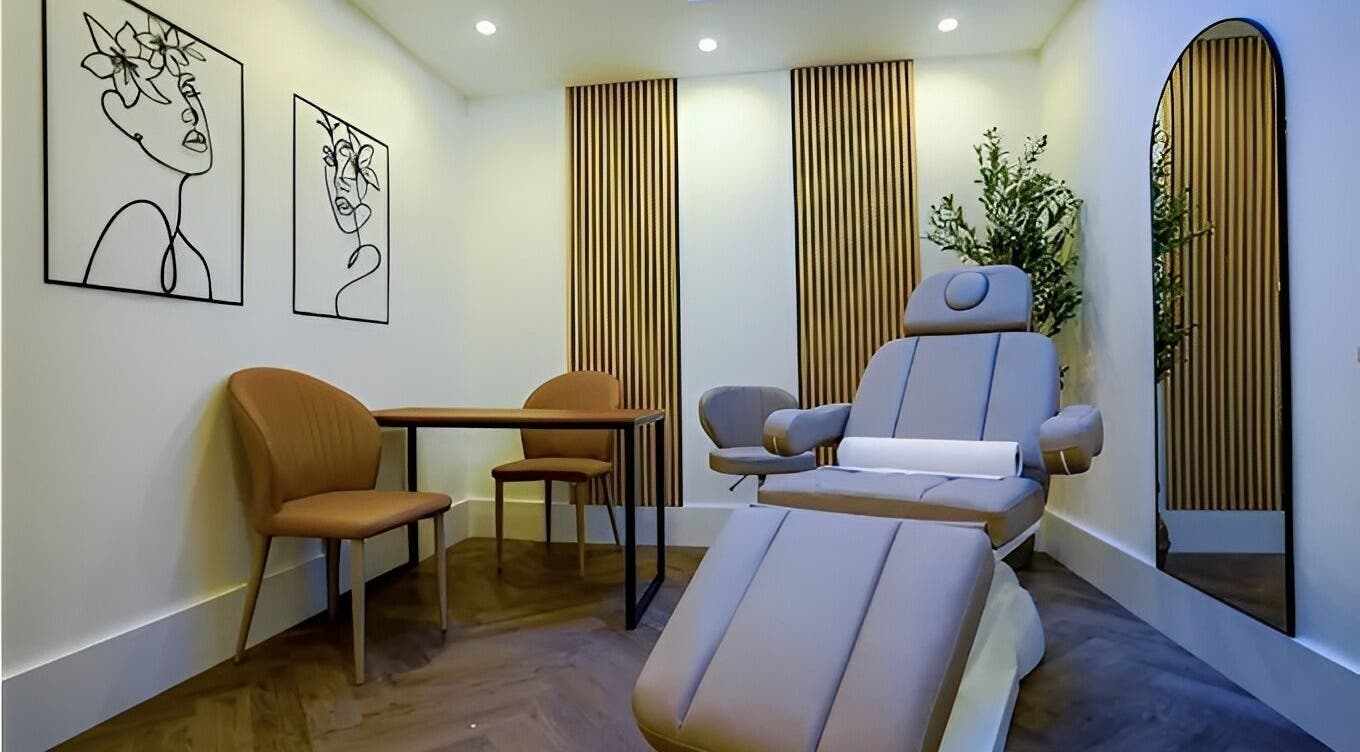 ELLO CLINIC's tranquil treatment room in London, England, GB showcasing modern chairs and decor.