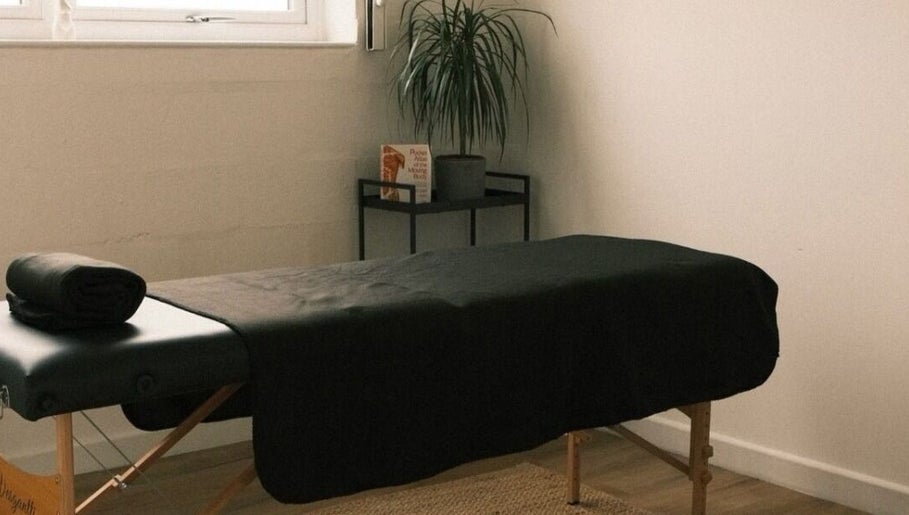 Tranquil massage room at Wellbeing with Lucy, Birkenhead, England, GB, featuring a treatment table and relaxing decor.