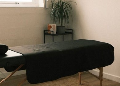 Tranquil massage room at Wellbeing with Lucy, Birkenhead, England, GB, featuring a treatment table and relaxing decor.
