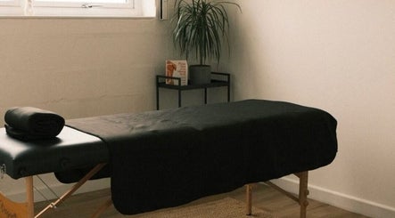 Tranquil massage room at Wellbeing with Lucy, Birkenhead, England, GB, featuring a treatment table and relaxing decor.