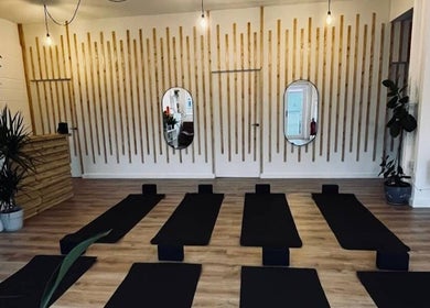 Peaceful yoga studio at Wellbeing with Lucy, Birkenhead, England, GB, featuring mats and a calming decor.