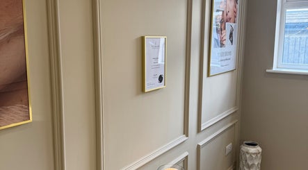Sophisticated interior wall at Elmwood Health & Beauty Ltd, Kirkby In Ashfield, featuring framed art and decor.
