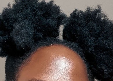 Afro puff hairstyle at Take Down & Detangle, Cardiff, Wales, GB. Perfect combination of style and texture.