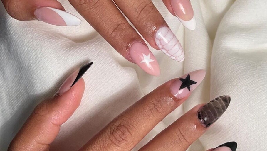 Stylish star-themed nail art at Cured in Cambridge, England, GB, showcasing intricate design details.