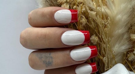 Red-tipped manicured nails at Cured, Cambridge, England, GB showcasing stylish nail art.