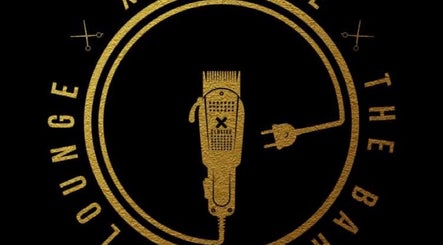 Golden logo of Xclusive The Barbering Lounge LLC, a barber shop in Chicago, Illinois, US, featuring clippers.