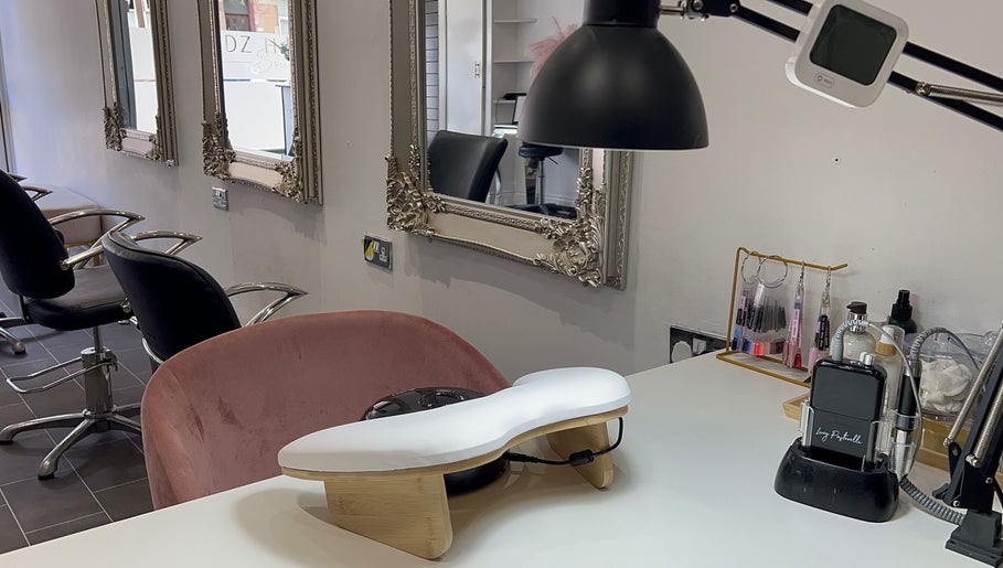 Chic nail station at HT Studio in Glasgow with plush seating and ornate mirrors.