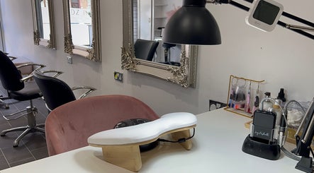 Chic nail station at HT Studio in Glasgow with plush seating and ornate mirrors.