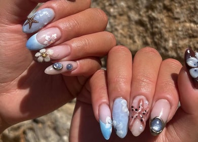 Intricate floral nail art at HT Studio, Glasgow, Scotland, GB, showcasing delicate sea-inspired designs.