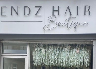 Front view of HT Studio in Glasgow, Scotland, GB with elegant floral decoration under the boutique sign.