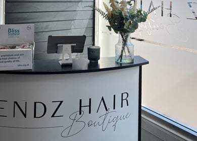 Reception at HT Studio in Glasgow, Scotland, GB featuring elegant decor and a charity donation box.